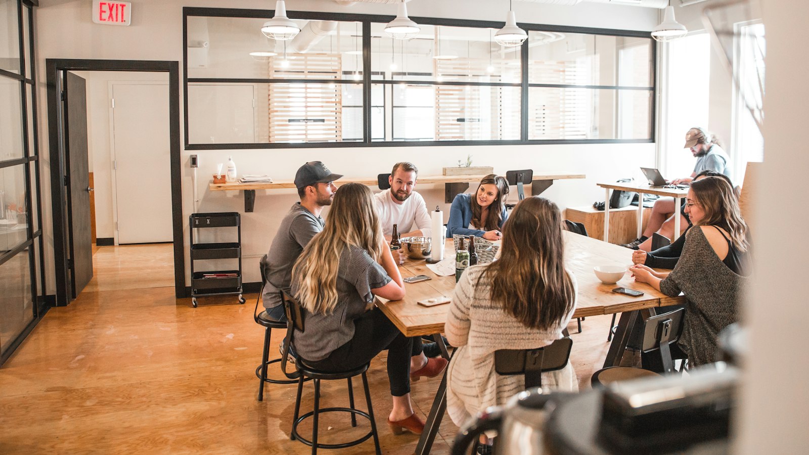 A small group of people in conversation around a meeting table.