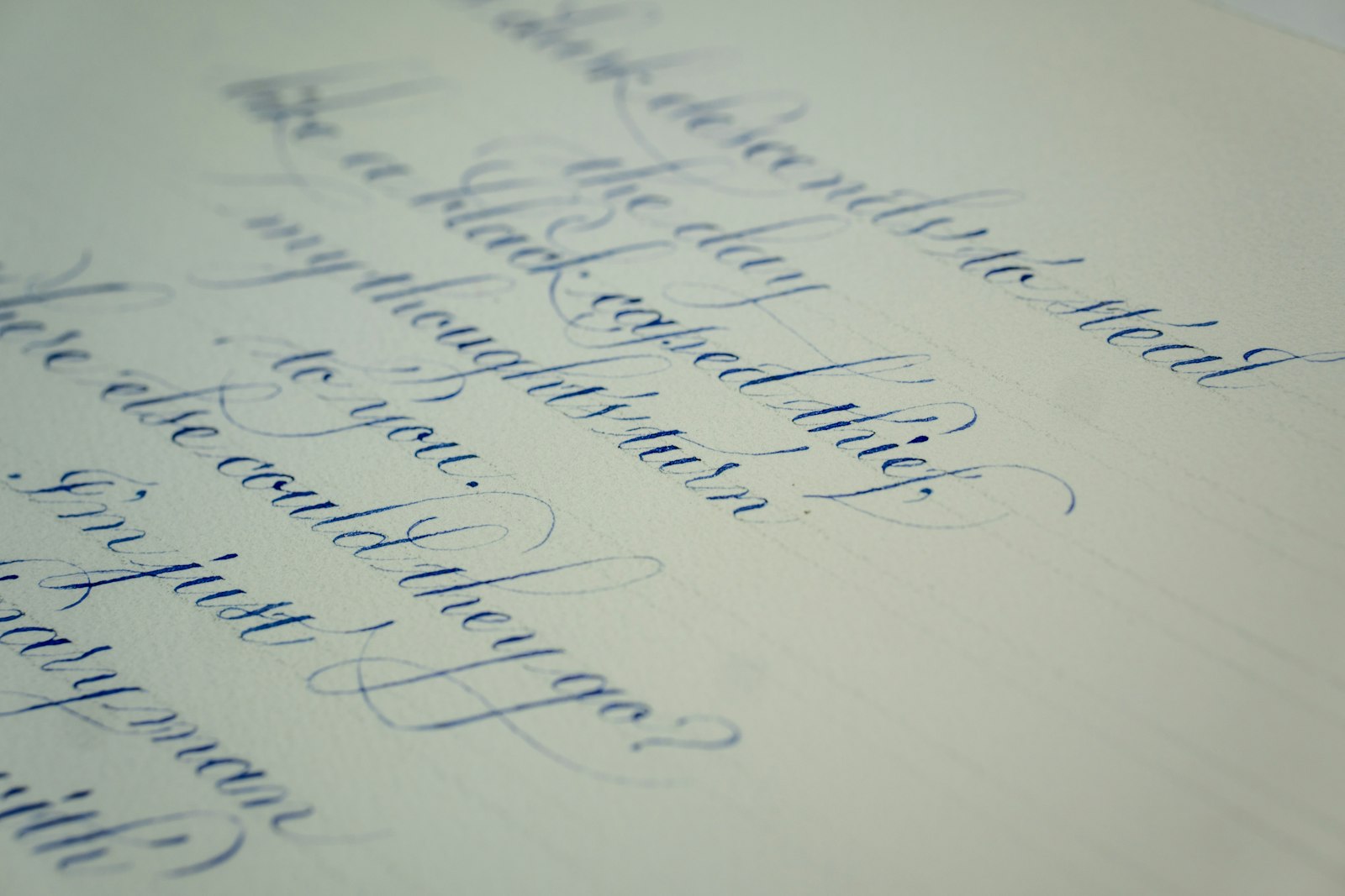 Close-up of a handwritten letter in looping script on a sheet of paper.